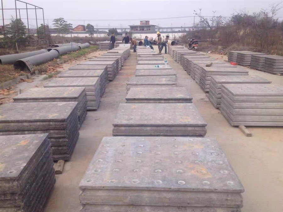 Batch of cast-in-place filter plates in the factory yard with workers