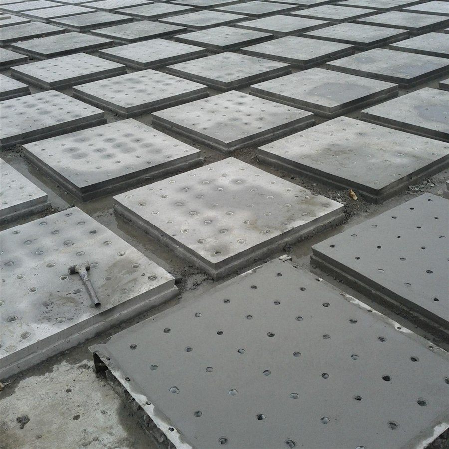 Concrete filter plates laid out in a grid in the yard