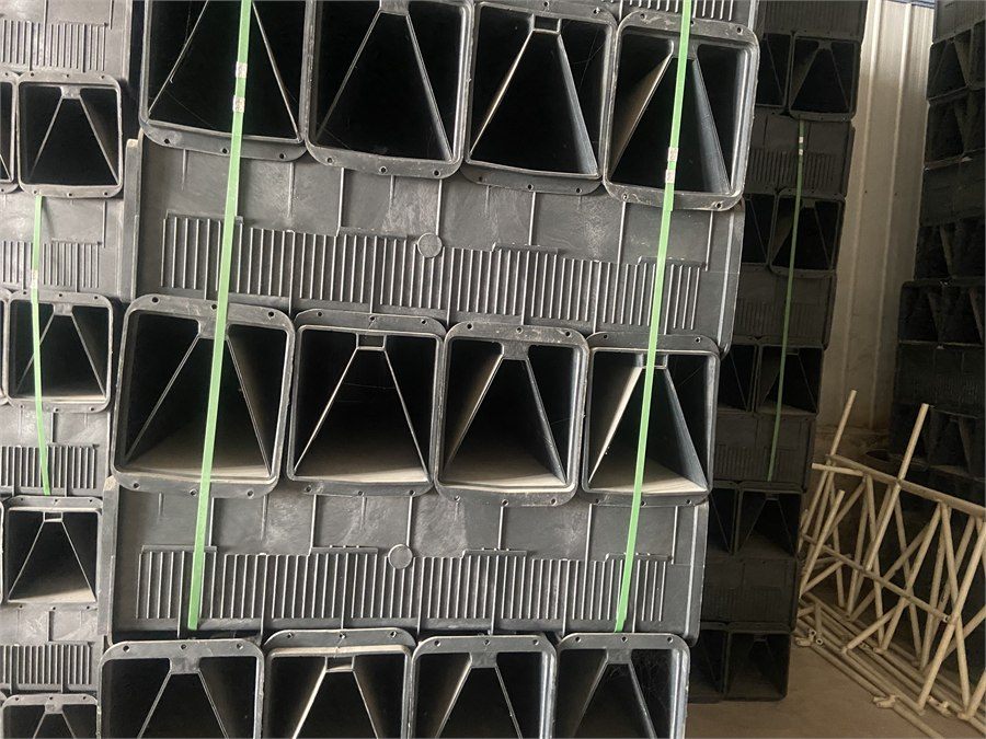 Stacked grey filter bricks with capping plates, banded with strapping