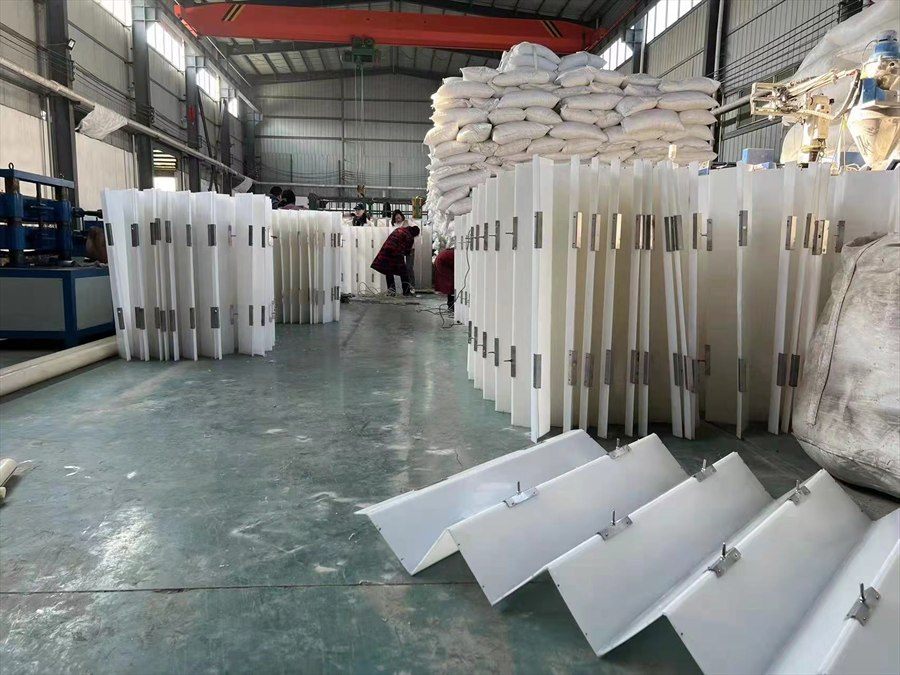 Batch of baffle boxes in the workshop with operators