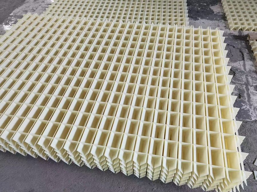 Ivory flocculation grid panels stacked in the workshop