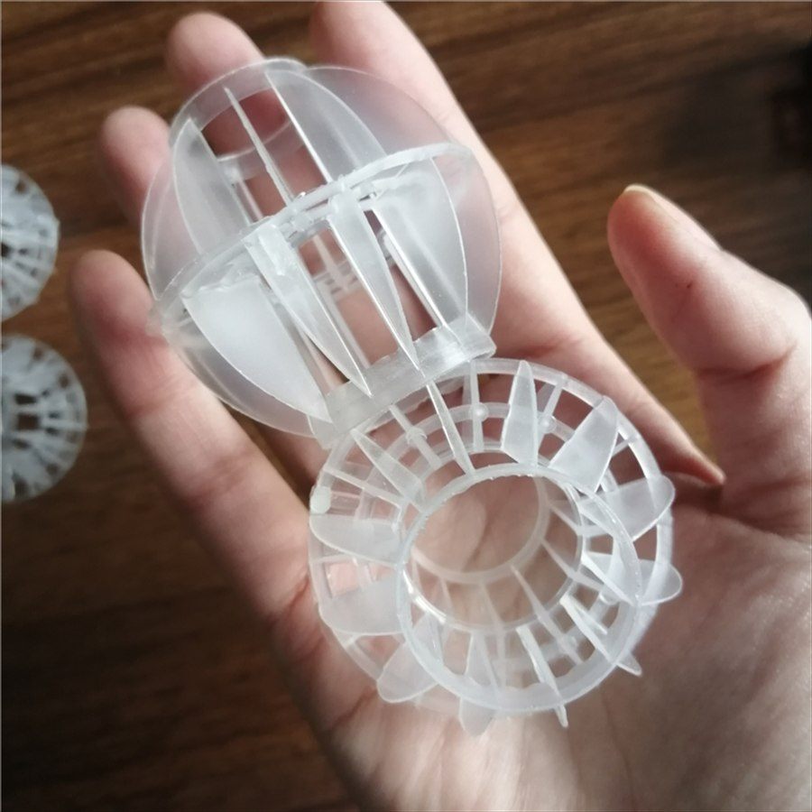 Multi-faceted hollow ball and cut section in hand