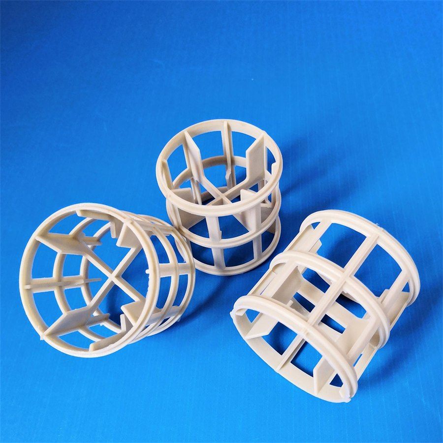 Off-white polypropylene Pall rings, three pieces, on a blue background