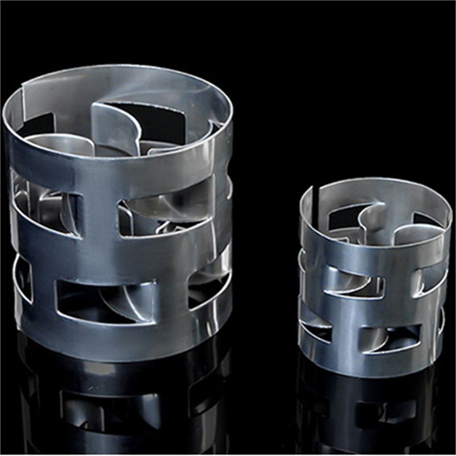 White polypropylene Pall ring packing in four different sizes on a reflective black background