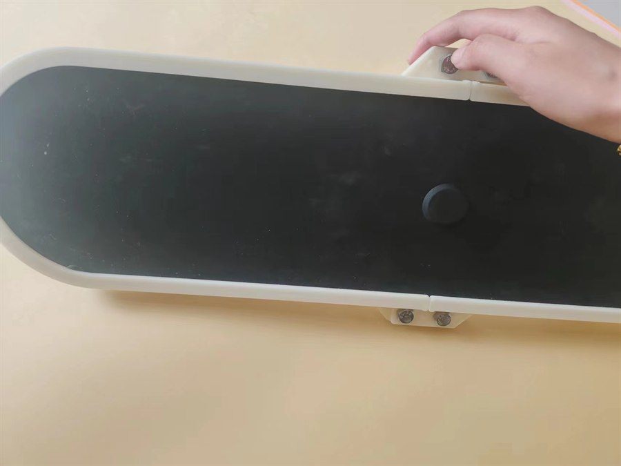 Plate aerator held by its edge, showing the membrane surface