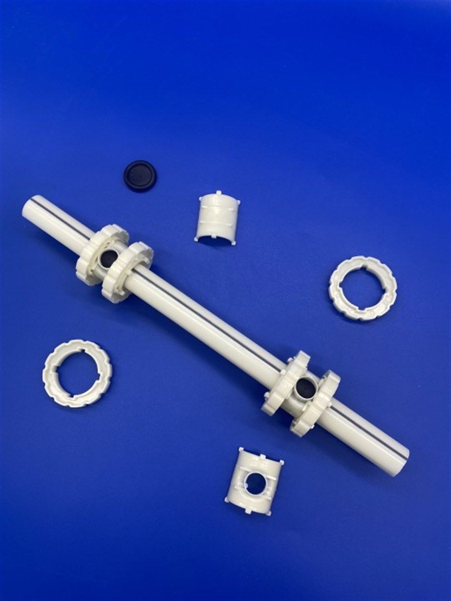 Disassembled aerator on a blue background: membrane disc, clamp rings, collar and body pipe