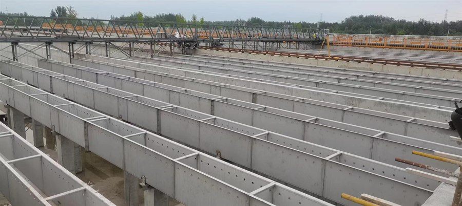 Perforated collection troughs laid in rows across a basin under construction