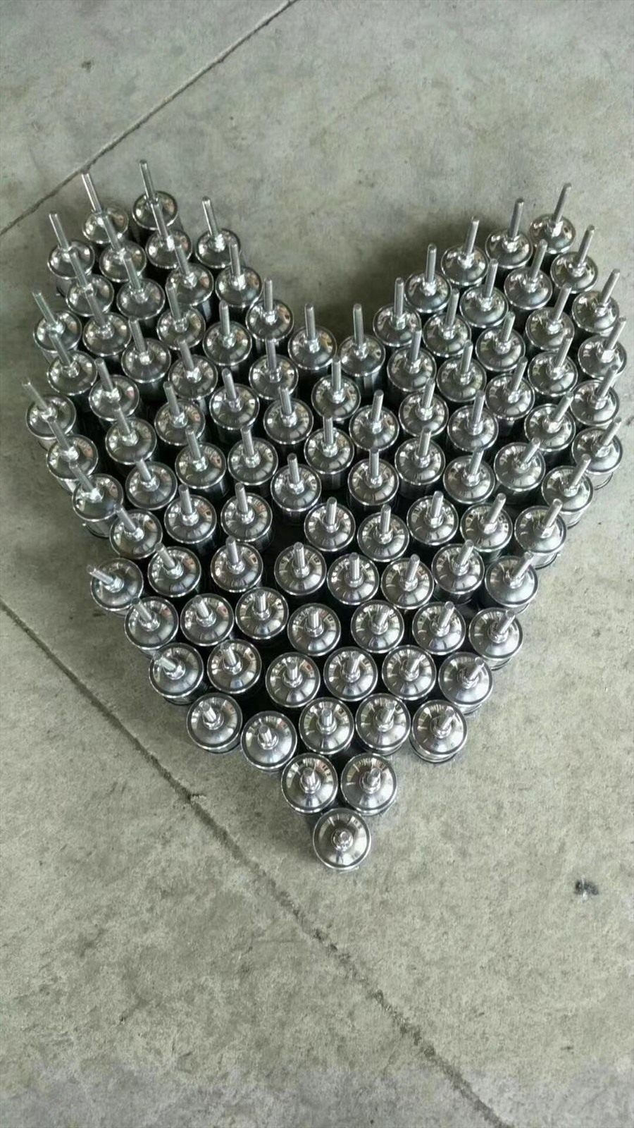 Drain caps arranged in a pattern on a workshop floor
