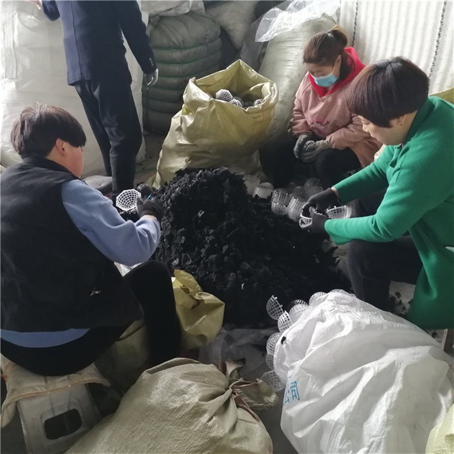 Workers filling suspended ball media